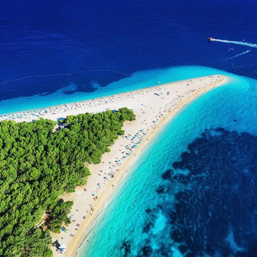 Aerial view of Zlatni Rat beach in Bol, Brač Island – a stunning golden pebble cape stretching into the turquoise Adriatic Sea.